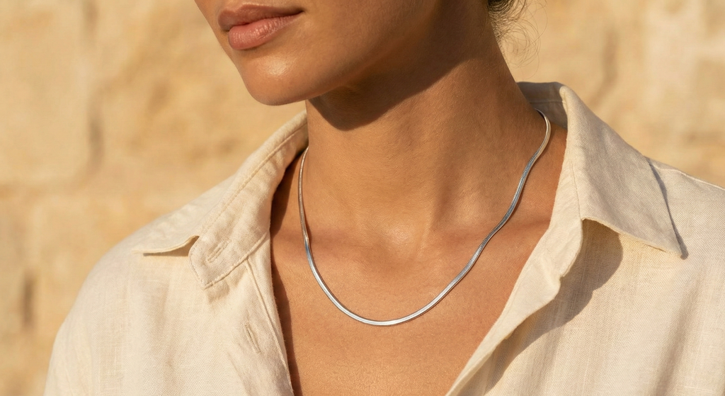 L'Eclat silver snake chain necklace on neck
