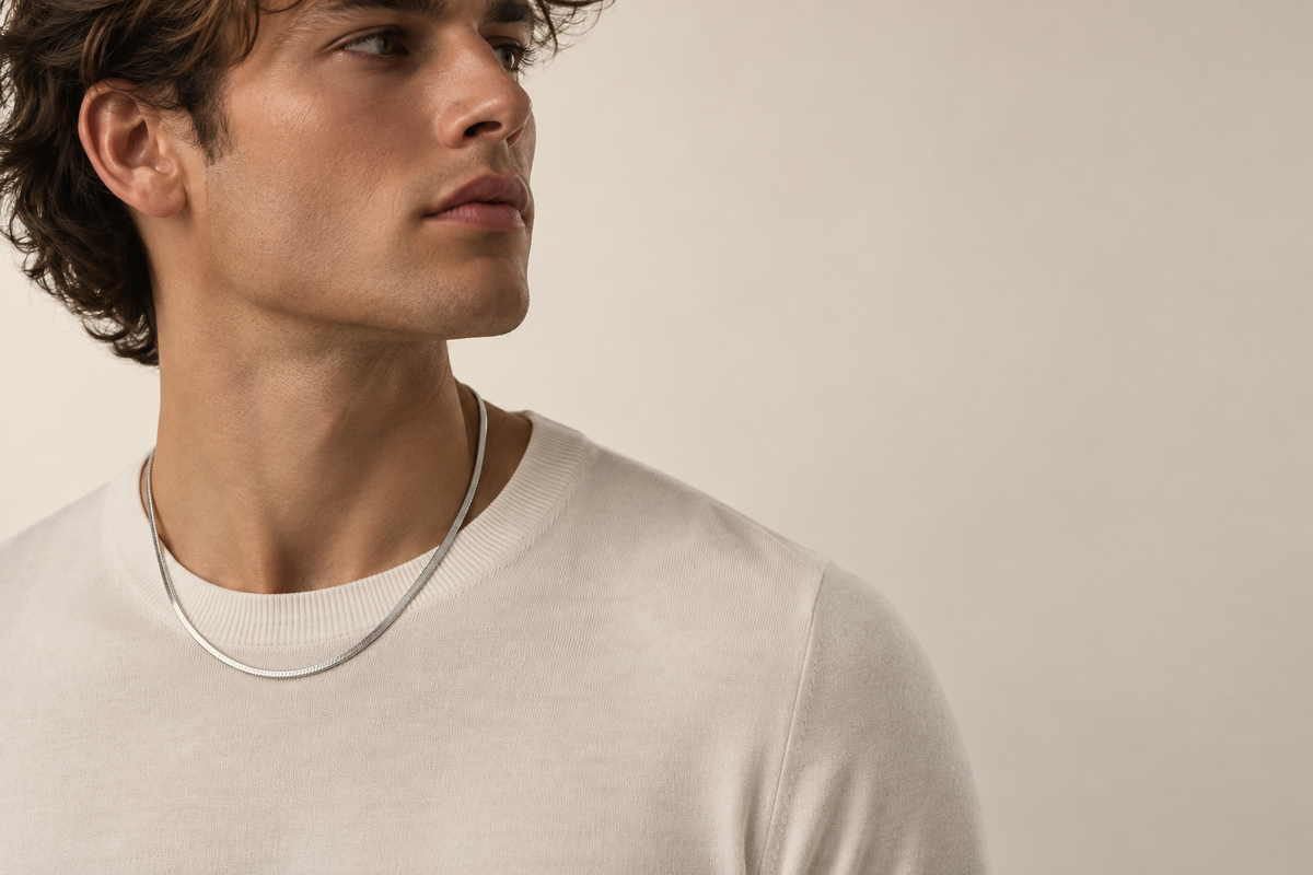 Man wearing the silver Fieré L’Éclat Necklace in a studio portrait